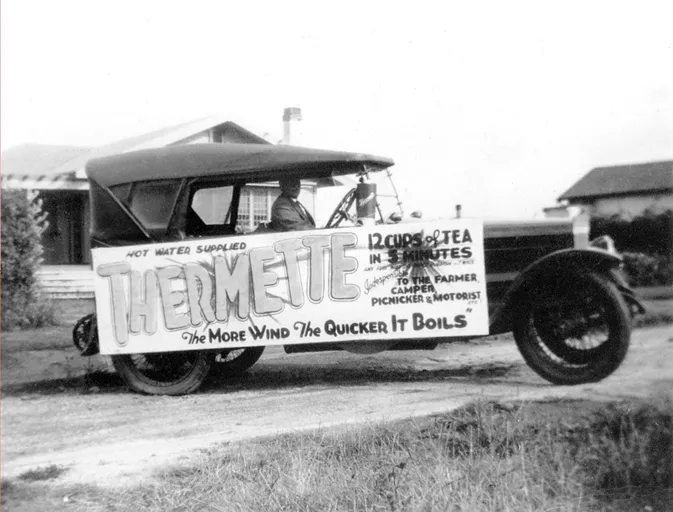 Vintage car displaying a thermette advertisement